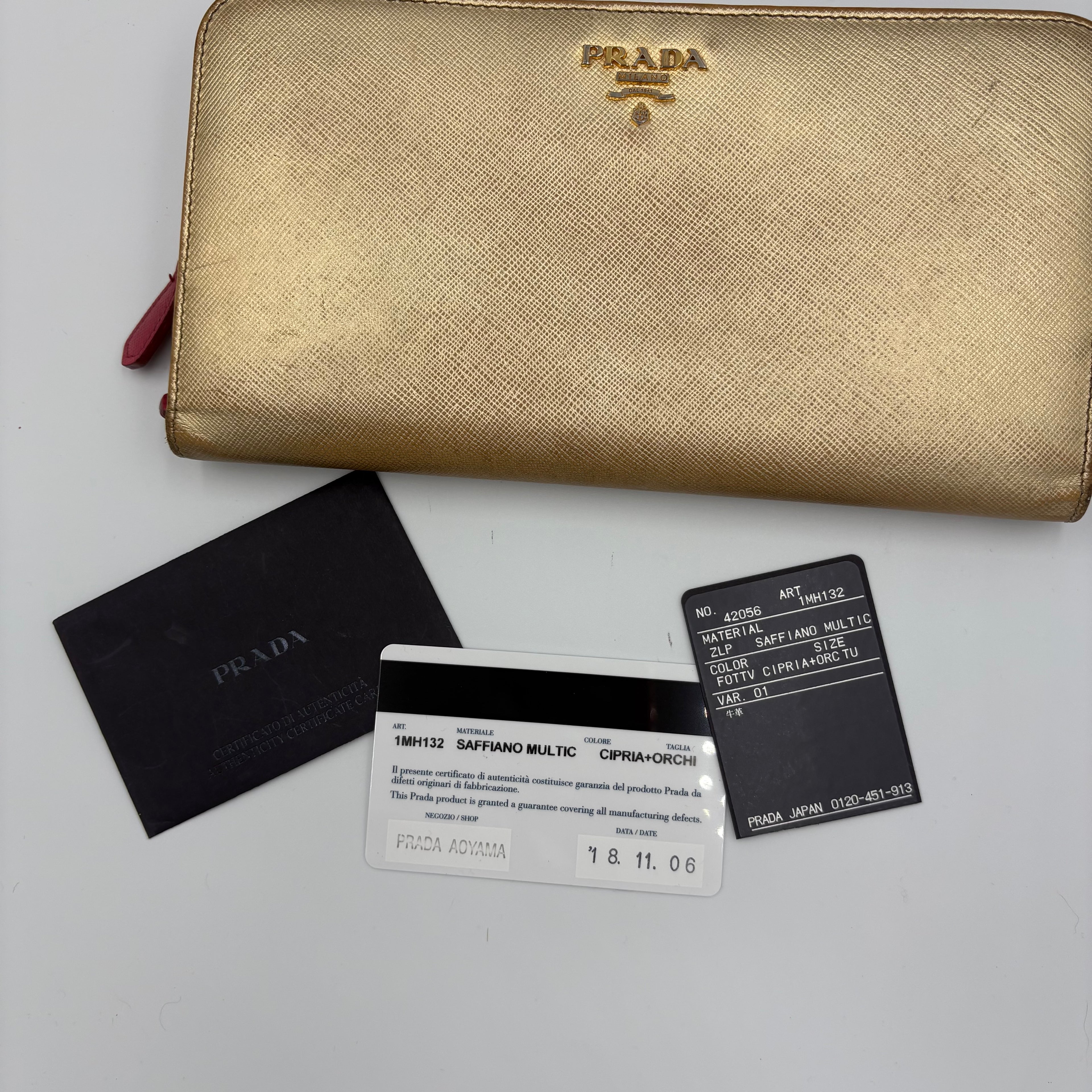 Gold Prada trifold wallet/ purse with pink interior