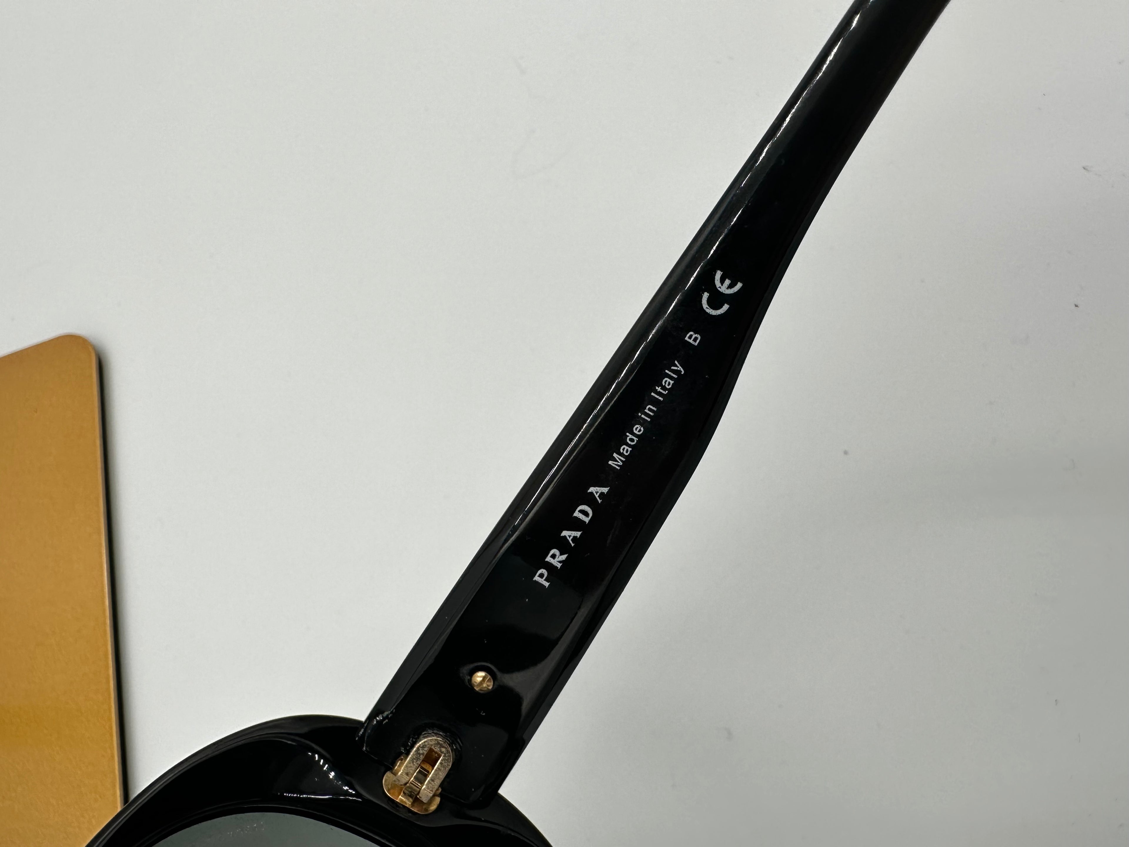 Prada Heritage black sunglasses with gold logo