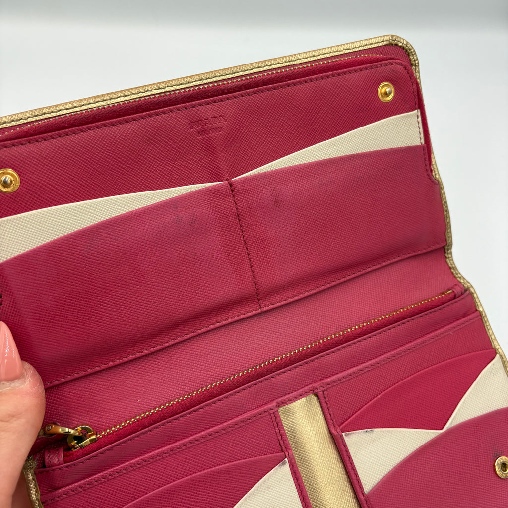 Gold Prada trifold wallet/ purse with pink interior