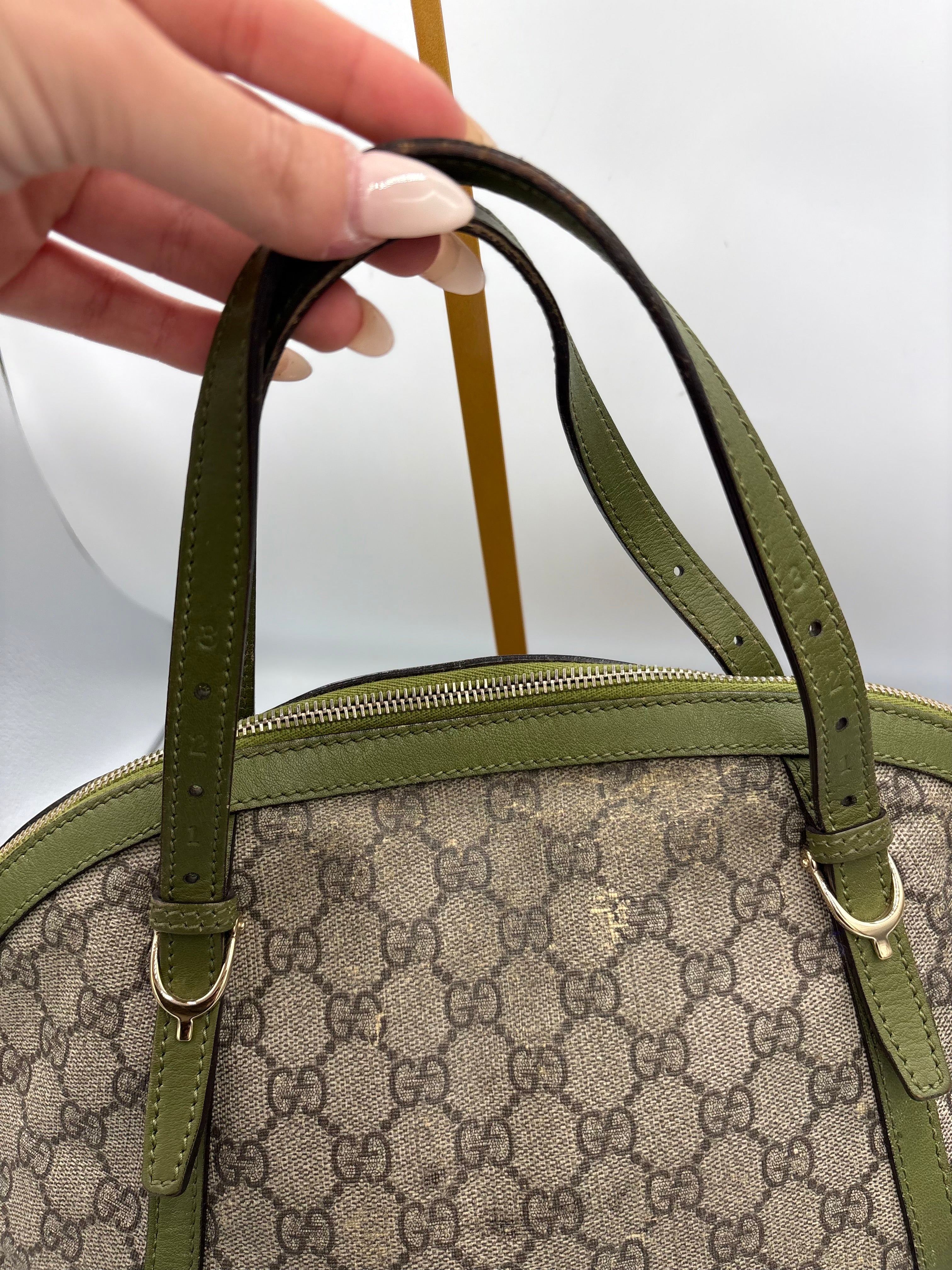 Gucci Ophidia dome top handle bag featuring monogram GG supreme canvas