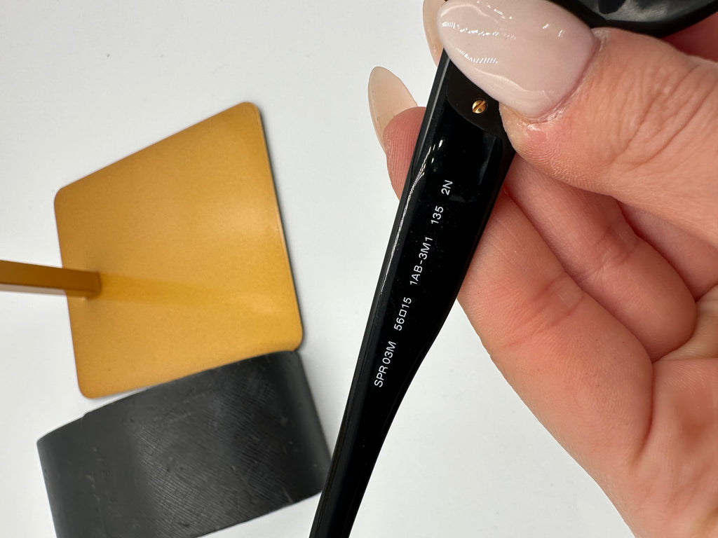 Prada Heritage black sunglasses with gold logo